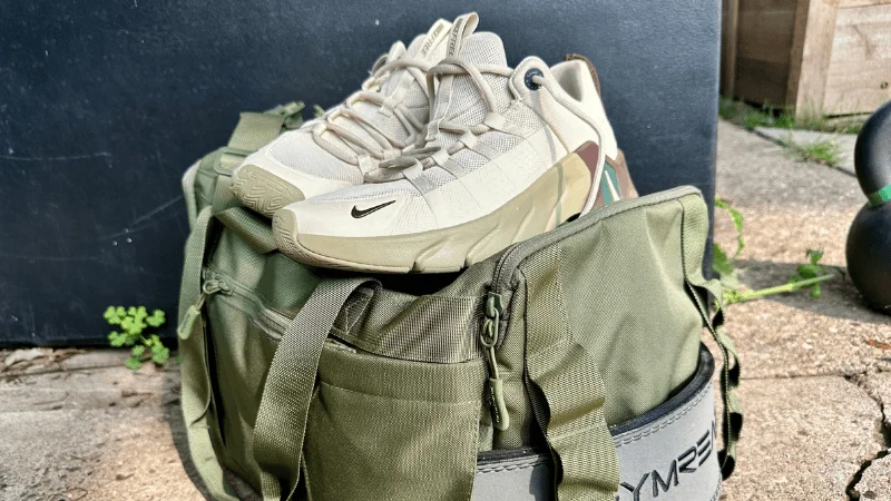 A pair of Nike Free Metcon 7 shoes perched neatly upon a gym bag.