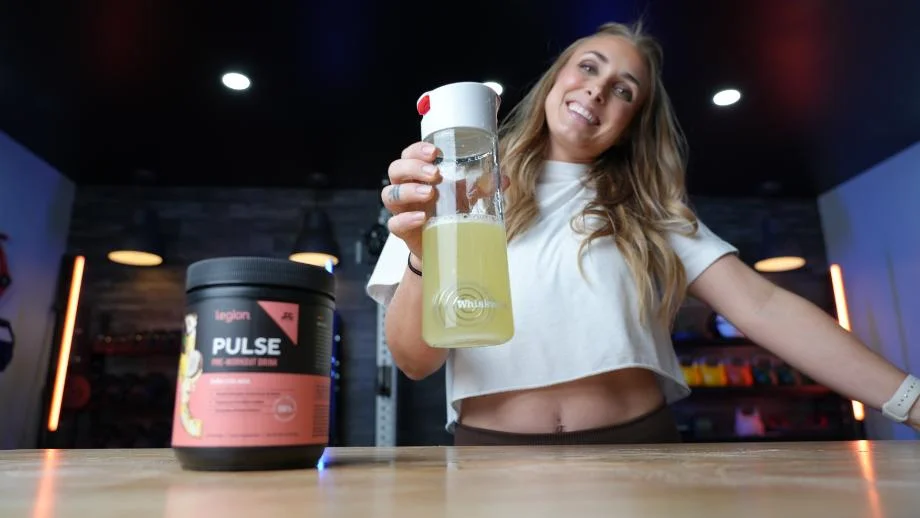 Lindsay holding Legion Pulse pre-workout drink after mixing it