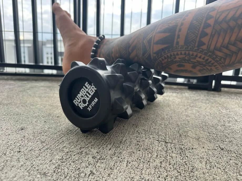 Our tester using a Rumble Roller on his calf.
