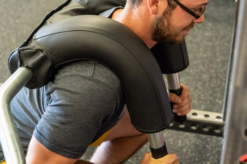 Side view of man squatting with the Marrs-Bar