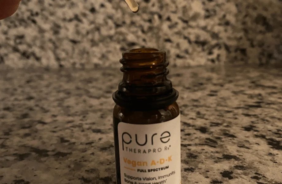 An open container of Pure TheraPro Rx Vegan A-D-K Drops