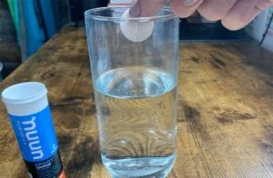 dropping a nuun sport electrolyte tablet into glass