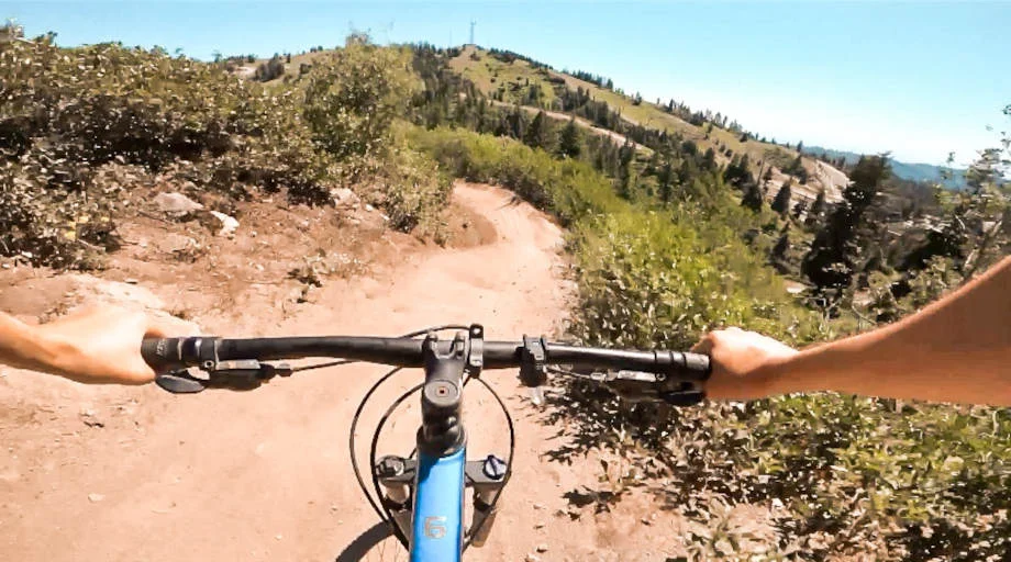 POV perspective riding down a dirt trail on a Trek Marlin 2