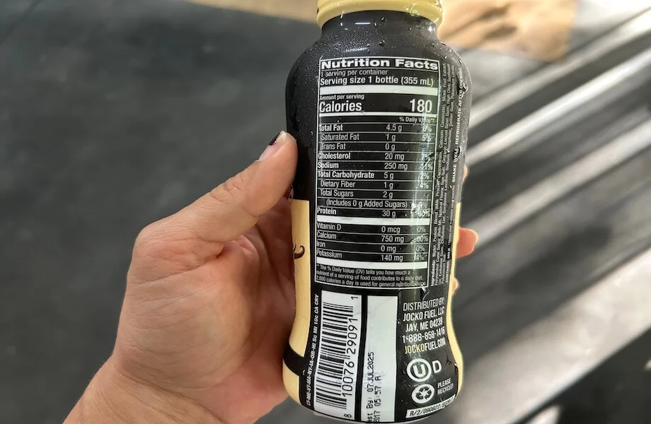 Our tester reading the nutrition facts of Jocko Molk Protein Shake