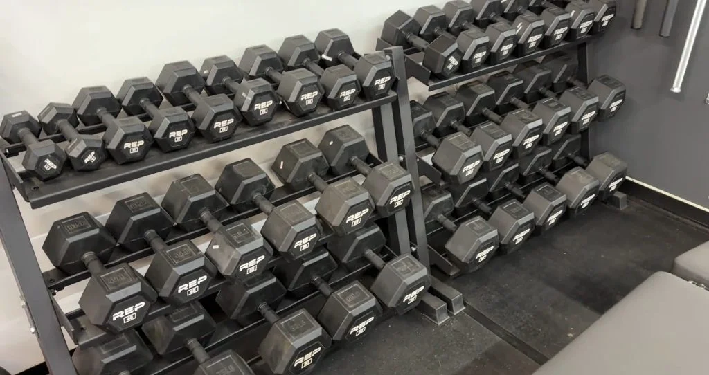 looking-at-a-large-colleciton-of-rep-fitness-rubber-coated-hex-dumbbells A large wall rack full of REP Fitness Rubber Coated Hex Dumbbells