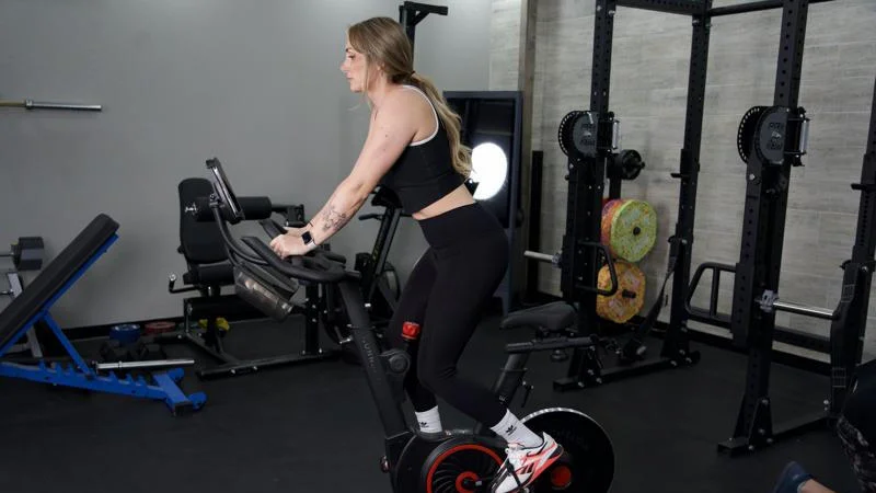 A woman riding the Echelon EX-5 exercise bike