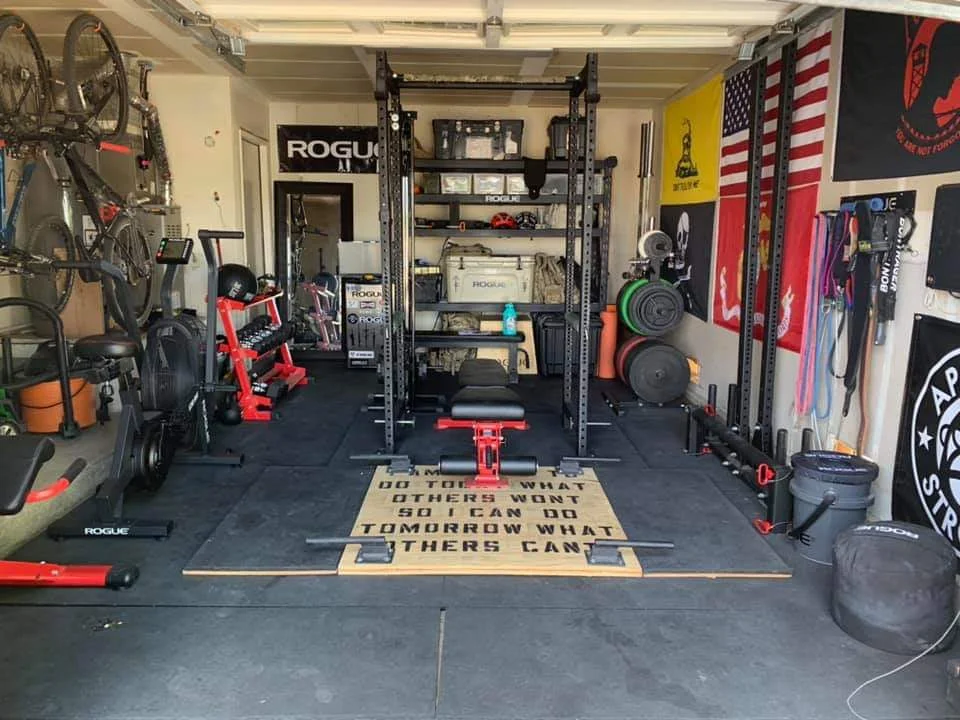a full garage gym set-up with power rack and weight