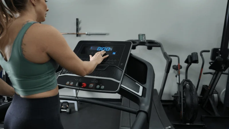 Our tester making some speed and incline adjustments on the ProForm Carbon TLX treadmill