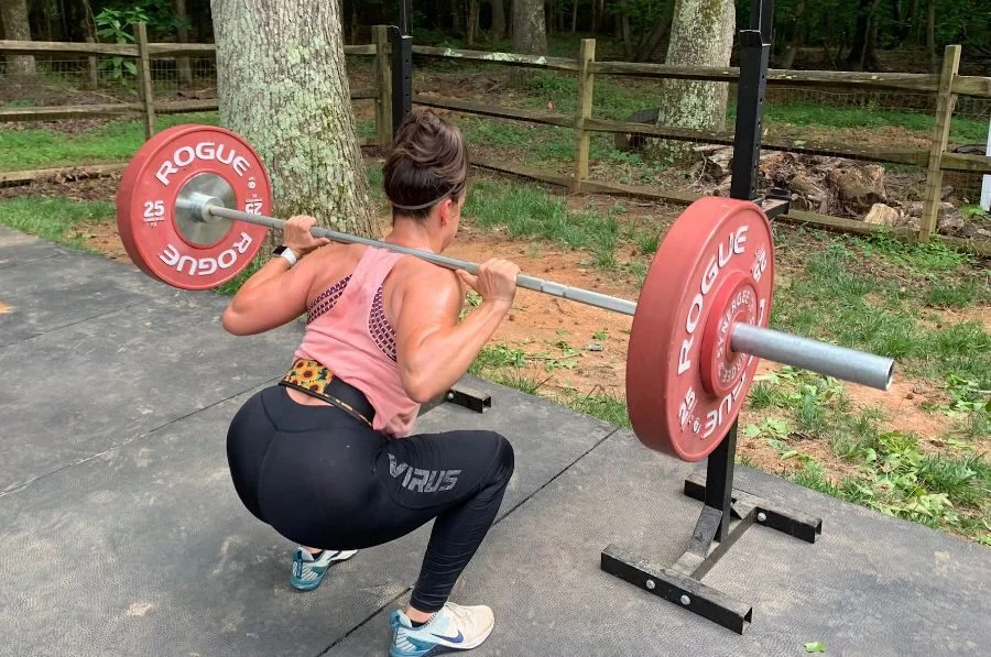 woman squatting barbell while wearing 2pood petite belt 1