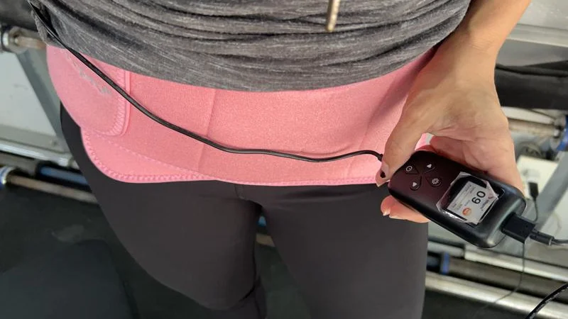 a-person-wearing-the-lifepro-allevared-light-therapy-belt-around-the-waist A person wears a LifePro AllevaRed Light therapy Belt around their waist.