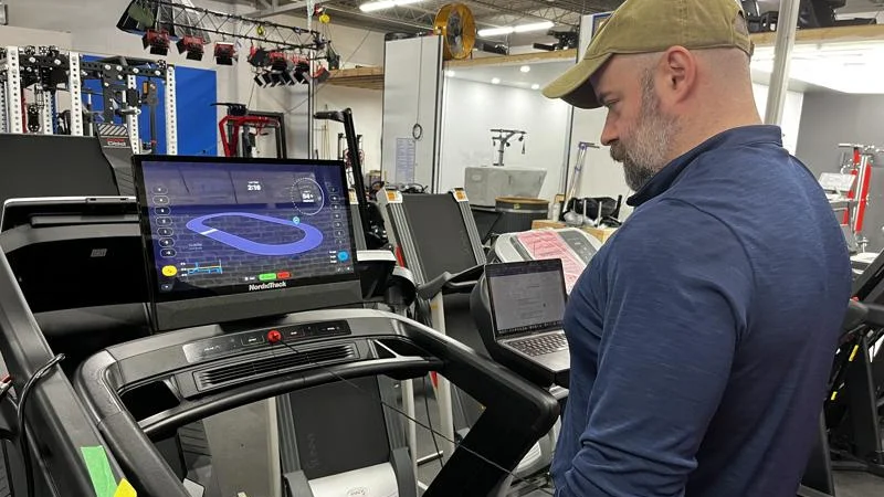Testing the safety cord length on a NordicTrack Commercial 2450 treadmill.