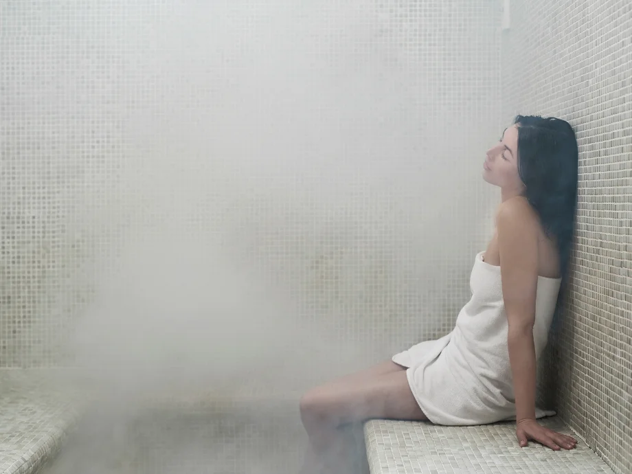 Steam room vs sauna woman relaxing in steam room