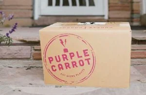 purple carrot meal delivery box on porch