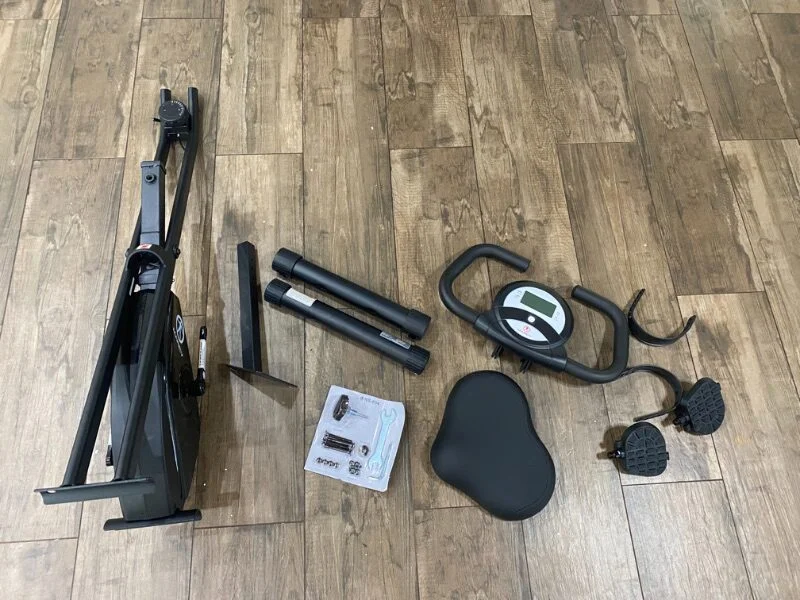 The unassembled pieces of a folding exercise bike