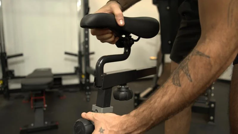 Adjusting the seat height on a Sunny Health and Fitness Synergy Magnetic Exercise Bike