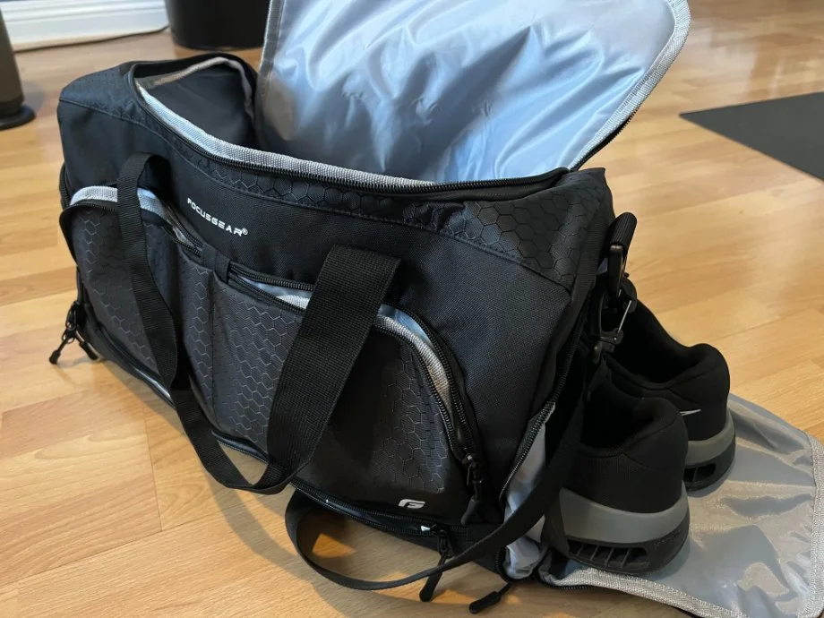 An opened FocusGear Gym Bag with Shoes hanging halfway out of a side pocket