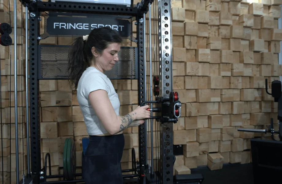 Our tester adjusting one of the Fringe Sport Dane 2.0's cable pulleys to their preferred height