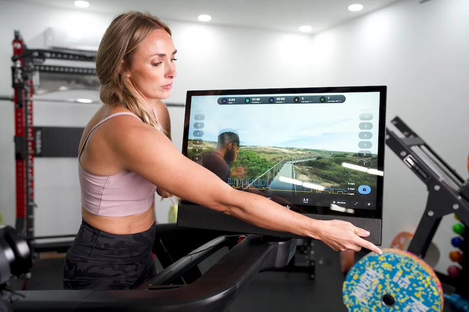 GGR Everything lead reviewer Lindsay Scheele showing the touchscreen display on the NordicTrack Commercial 2450 treadmill