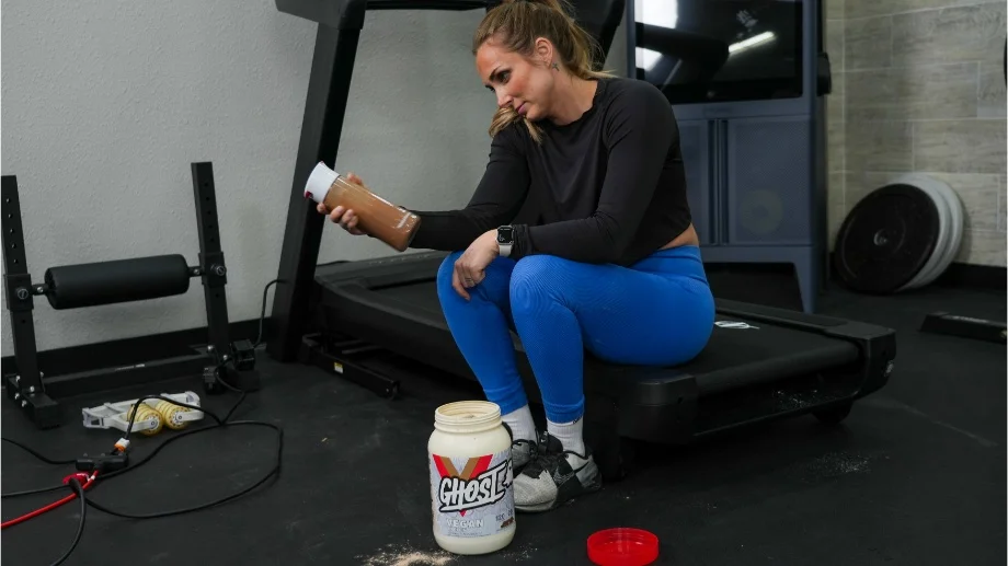 Our tester looks at a shaker glass of Ghost Vegan Protein.