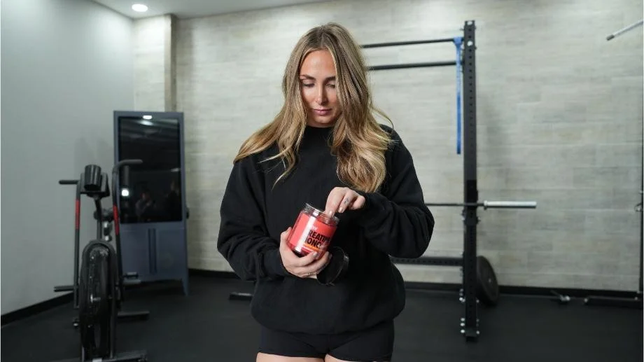 Our tester reaches into a tub of Swoly Creatine Gummies.