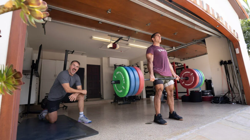 Coop hanging out at Jason Khalipa's garage gym watching Jason do deadlifts.