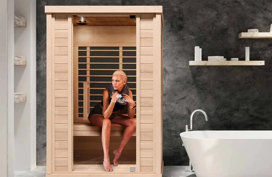 A woman sitting in the Sunlighten Amplify II