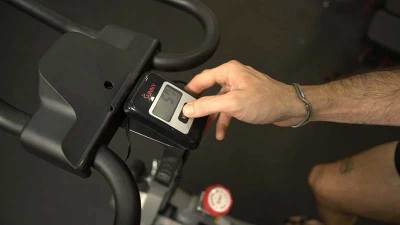 Our tester uses the console on a Sunny Health and Fitness Synergy Magnetic Exercise Bike.
