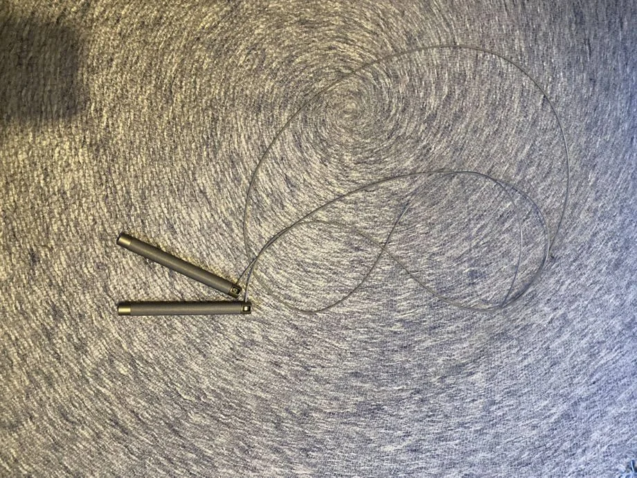 Overhead view of the black RPM sprint jump rope, showcasing the lightweight and minimalist design ideal for speed workouts.