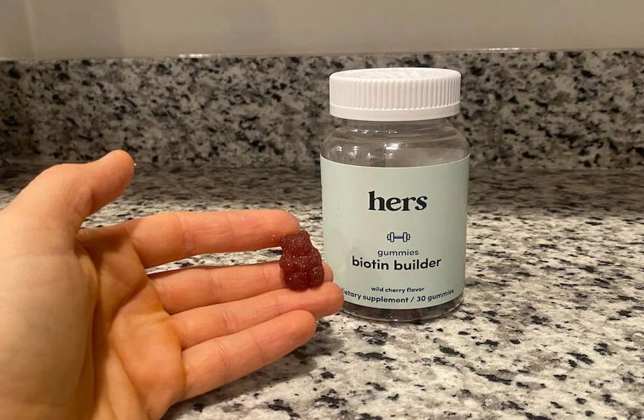 Our tester holding a single Hers Biotin Multivitamin gummy bear