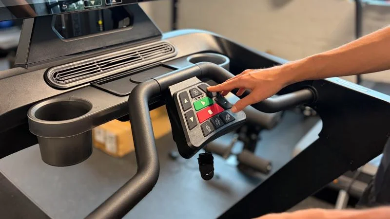 Our tester using the controls on an Aviron Justice Treadmill
