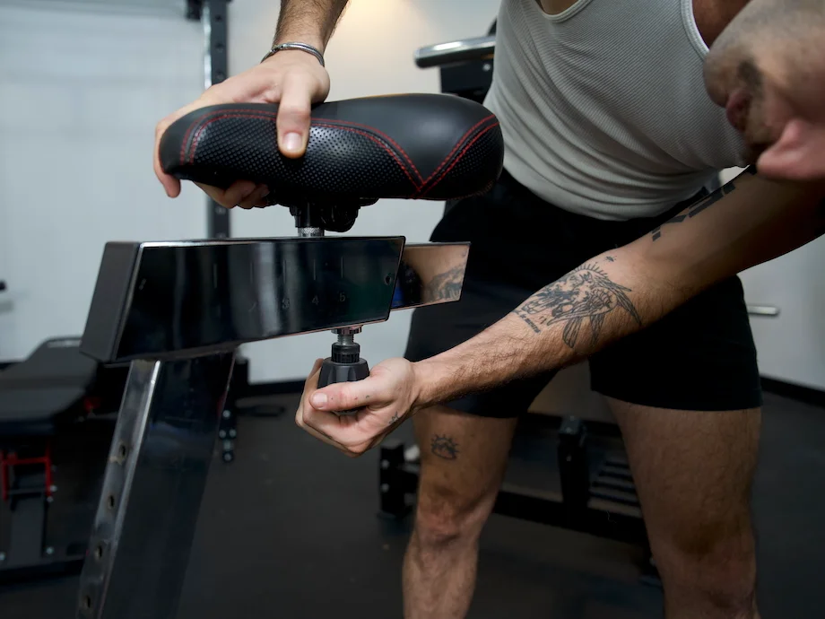 Man adjusts the seat on the Rogue Echo bike