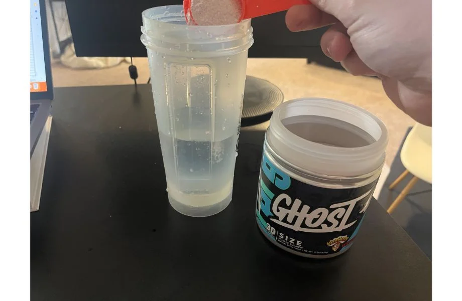 ghost_muscle_size_being_scooped_into_bottle_with_water