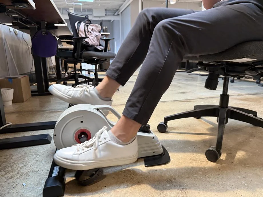 A person using a Sunny Health & Fitness Magnetic Mini Exercise Bike
