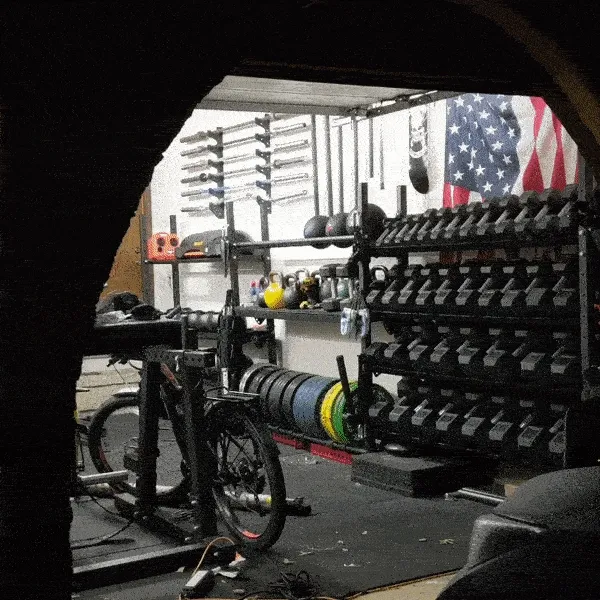 gif of walking into a garage gym with a full dumbbell rack set-up