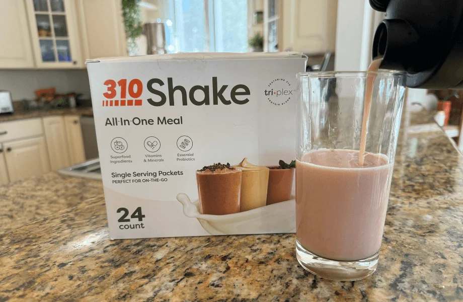 Our tester pouring a blended 310 All-in-One Meal Replacement Shake into a glass
