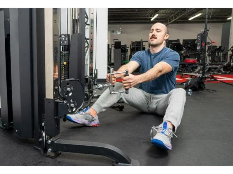 Coop performing seated rows on the Titan Fitness Functional Trainer