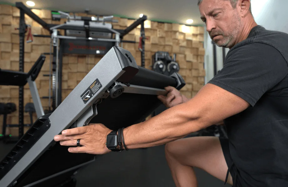 Our tester adjusting the incline on the Wellfit TM024 Treadmill