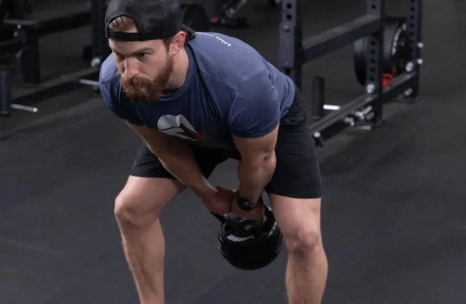 Man performing a kettlebell swing with the Titan Fitness Adjustable Kettlebell