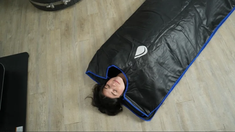 Our tester using the Sun Home Sauna Blanket