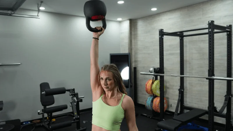 Our tester lifting the REP Fitness Adjustable Kettlebell overhead