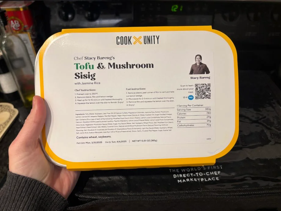 Looking down at a CookUnity meal in hand.