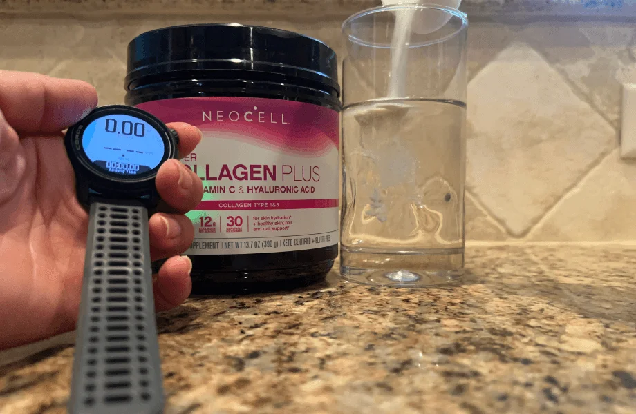 Our tester timing how long NeoCell Collagen takes to completely dissolve in a glass of water