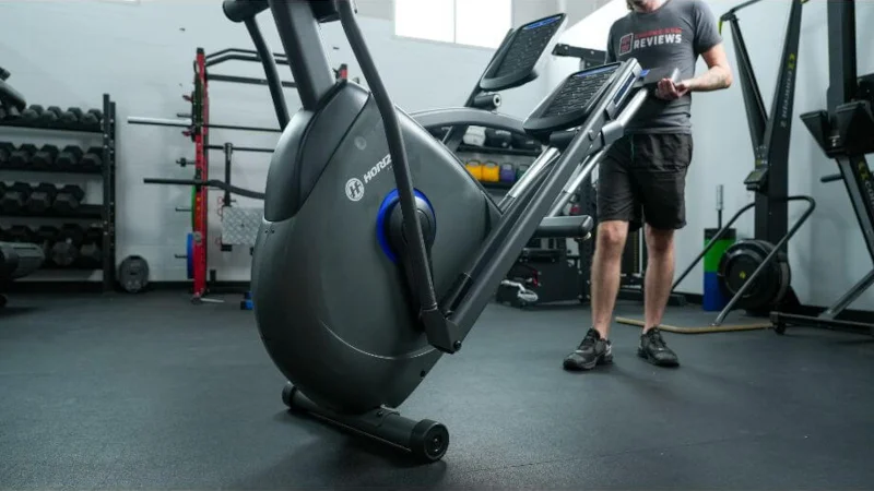 A person moves a Horizon EX-59 Elliptical machine.