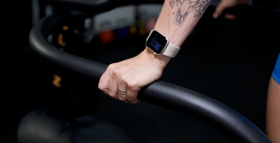A person works on while wearing an Apple Watch