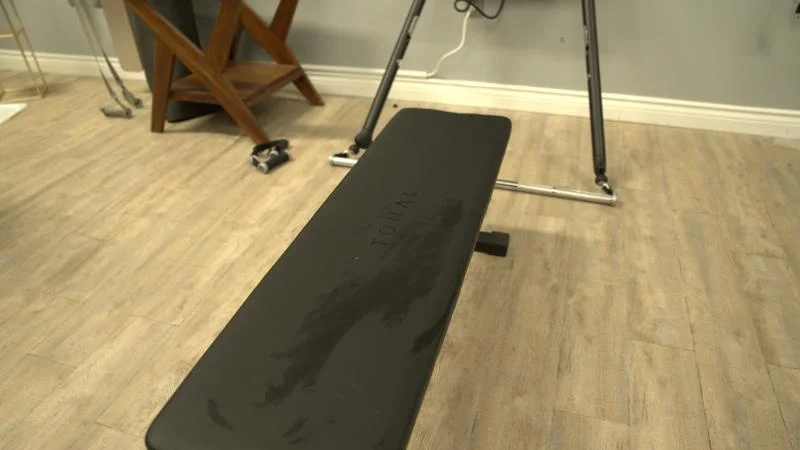 Looking down at the weight bench for a Tonal 2 Smart Home Gym.
