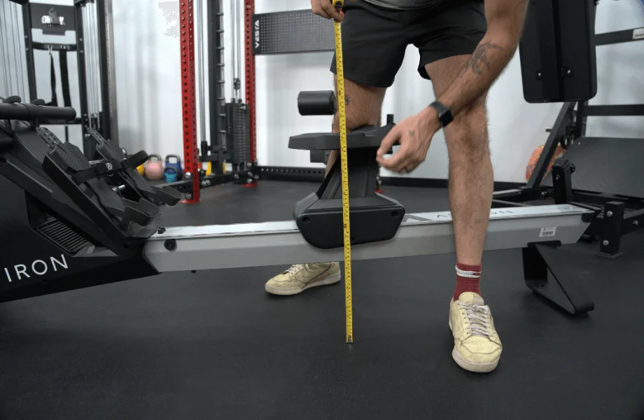 Our tester measuring the seat height of an Aviron rowing machine