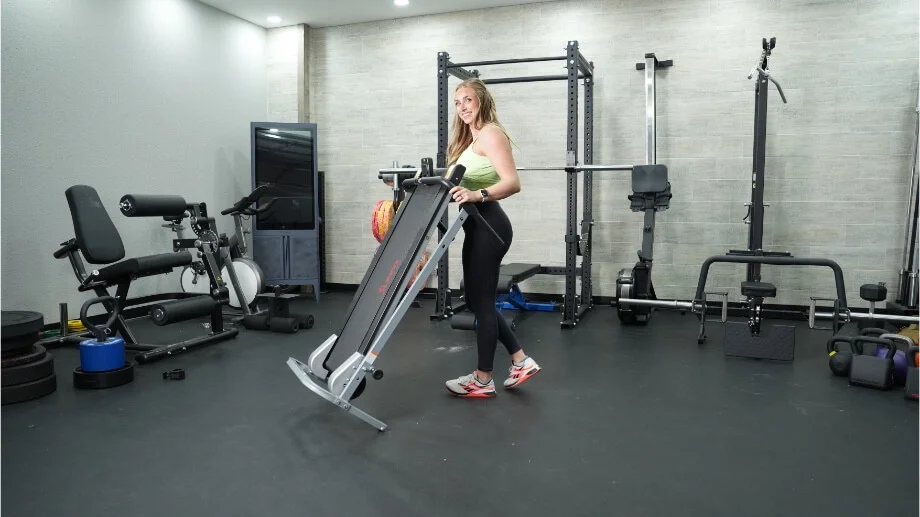 Product tester moving the Sunny Health and Fitness Manual Treadmill