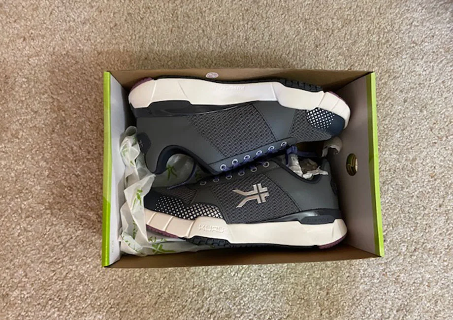 Looking down into a shoebox containing a new pair of KURU QUANTUM 2.0 shoes..
