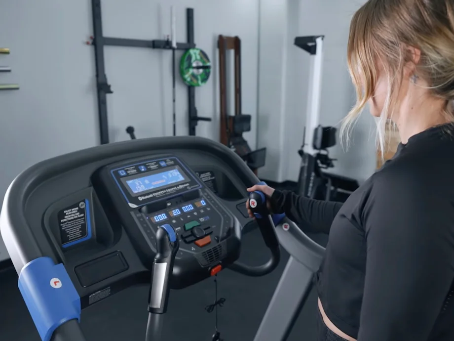 Product tester looking at the console on the Horizon 7.0 AT treadmill