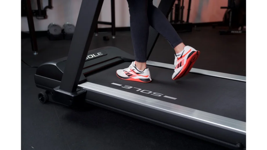 woman's feet running on sole fitness tt8 treadmill